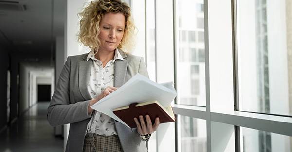 female professional holding papers