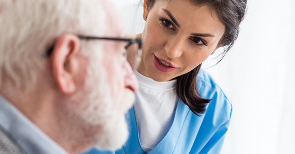 Elderly patient and caregiving nurse
